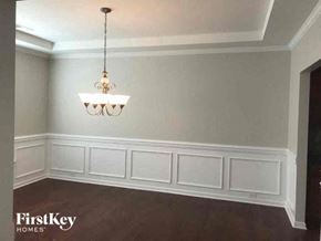 Belmont house for rent - a dining room with white walls and a chandelier