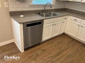 Acworth house for rent - a kitchen with white cabinets and a sink
