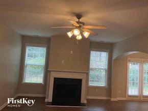 Acworth house for rent - a living room with a ceiling fan and a fireplace