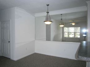 Bradenton house for rent - an empty dining room with a mirror and a table