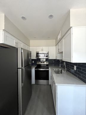 Phoenix apartment for rent - an empty kitchen with stainless steel appliances and white cabinets