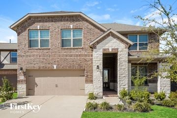 Richmond house for rent - a large brick house with a garage door