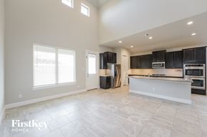 Richmond house for rent - a kitchen with black cabinets and stainless steel appliances