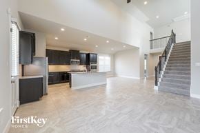 Richmond house for rent - an open kitchen and living room with stairs to the second floor