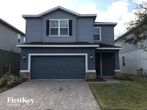 Riverview house for rent - a blue house with a driveway and a garage door