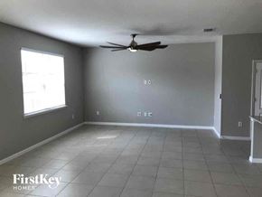 Riverview house for rent - an empty living room with a ceiling fan