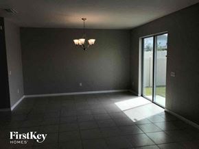 Riverview house for rent - an empty living room with dark walls and a sliding glass door