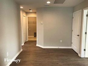 Riverview house for rent - an empty hallway with wood floors and white walls