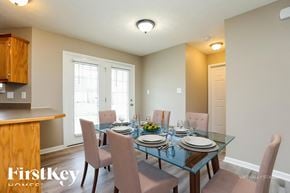 Clarksville house for rent - A dining room with a glass table and chairs.