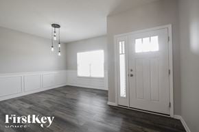 Greenfield house for rent - A room with a wooden floor and a white door.