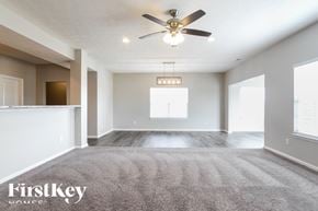 Greenfield house for rent - A spacious room with a ceiling fan and a rug on the floor.