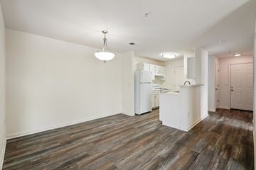 Herndon apartment for rent - A kitchen area with a white refrigerator and wooden flooring.