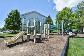 Herndon apartment for rent - a playground with slides and a house in a park