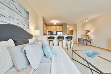 Minneapolis apartment for rent - A modern living room with a grey sofa and a glass coffee table.