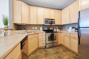 Minneapolis apartment for rent - A kitchen with wooden cabinets and a tile floor.
