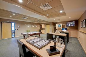 Minneapolis apartment for rent - A conference room with a tables and chairs and a TV on the wall.