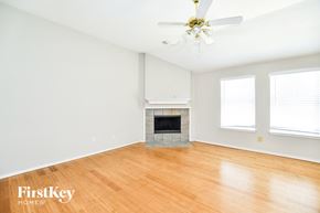 Garland house for rent - a living room with a fireplace and a wooden floor