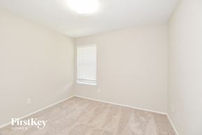 Garland house for rent - a spacious room with white walls and a window and a carpeted floor