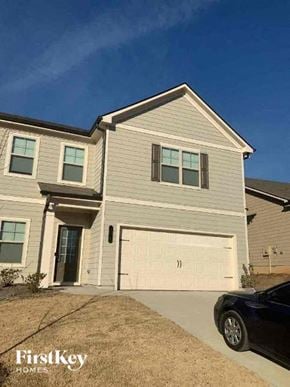 Auburn house for rent - a white house with a white garage door