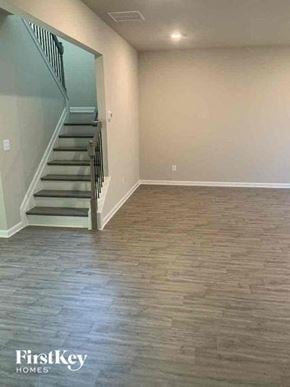 Auburn house for rent - a empty living room with a staircase and wood floors
