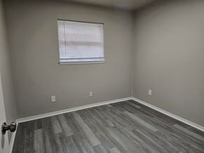 Oklahoma City house for rent - A room with a window and wooden flooring.