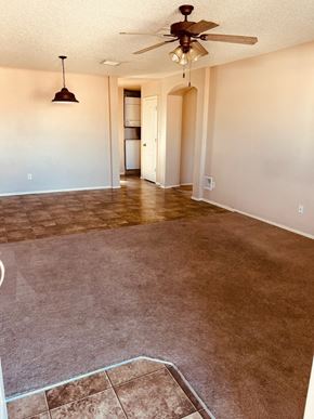 El Paso apartment for rent - an empty living room with carpet and a ceiling fan