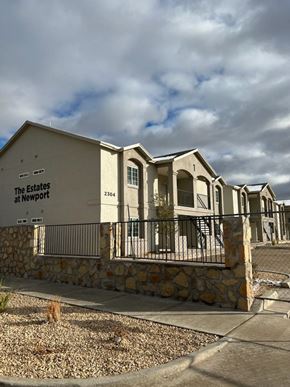 El Paso apartment for rent - a building with a stone wall and a fence in front of it