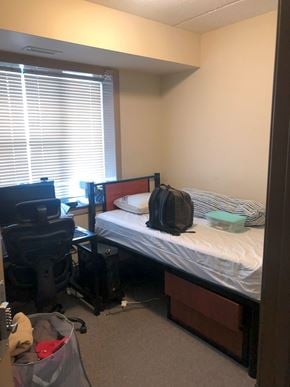 Waterloo apartment for rent - A small bedroom with a bed, desk, and chair.