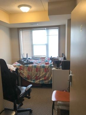 Waterloo apartment for rent - A small office with a bed in the corner.