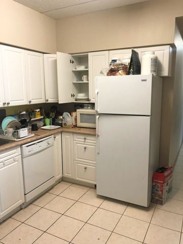 Waterloo apartment for rent - A white refrigerator is in a kitchen with white cabinets.