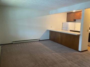 Louisivlle apartment for rent - A kitchen area with a refrigerator and cabinets.