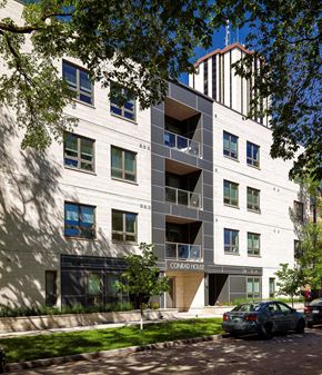 Winnipeg apartment for rent - a white apartment building with a car parked in front of it