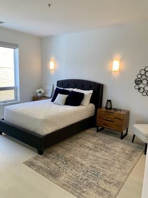 Winnipeg apartment for rent - a bedroom with a bed and two nightstands and a window