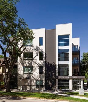 Winnipeg apartment for rent - a white building with a tree in front of it