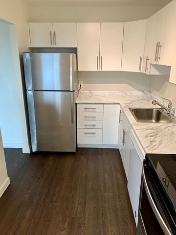 Winnipeg apartment for rent - a kitchen with white cabinets and a stainless steel refrigerator