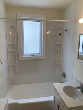 Winnipeg apartment for rent - a bathroom with a sink and a bath tub and a window