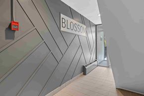 Ottawa apartment for rent - A hallway with a wall that has the word "BLOSSOM" on it.
