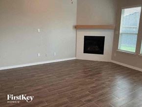 Haslet house for rent - a living room with a fireplace and a wooden floor