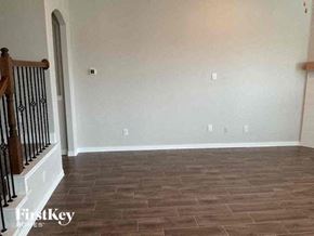 Haslet house for rent - a empty living room with white walls and a wooden floor