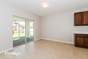 Cape Coral house for rent - a living room with a sliding glass door to the yard