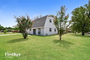 Irving house for rent - a white house with a yard and some trees