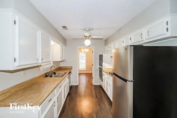 Germantown house for rent - A kitchen with wooden countertops and white cabinets.