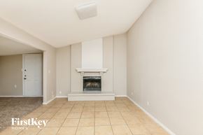 Fort Worth house for rent - A room with a fireplace and a door on the left side.