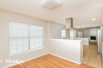 Fort Worth house for rent - A kitchen area with a stove and a refrigerator.