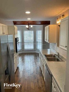 Waxhaw house for rent - a kitchen with stainless steel appliances and white cabinets