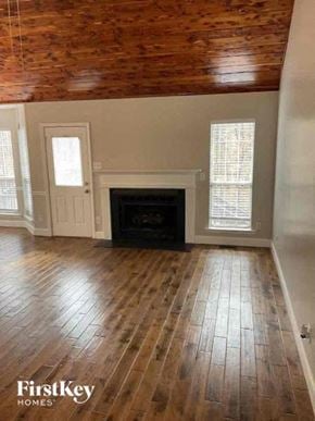 Waxhaw house for rent - a living room with a wood floor and a fireplace