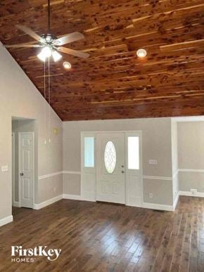 Waxhaw house for rent - an empty living room with a ceiling fan and wood floors