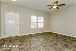 Wendell house for rent - A room with a white door and a ceiling fan.