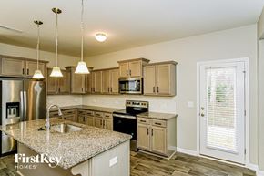 Wendell house for rent - A kitchen with granite countertops and stainless steel appliances.