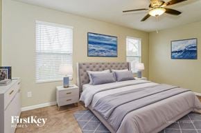 Wendell house for rent - A bedroom with a bed, nightstands, and pictures on the wall.